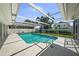 Enjoy the refreshing pool inside the screened enclosure, complete with a spacious deck and lush landscaping at 5884 51St S St, St Petersburg, FL 33715