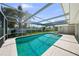 This inviting pool features a screened enclosure and a spacious deck, all surrounded by beautiful landscaping at 5884 51St S St, St Petersburg, FL 33715