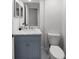Stylish powder room with a blue vanity, white marble countertop, and modern fixtures at 5884 51St S St, St Petersburg, FL 33715