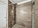 Modern bathroom featuring a tiled walk-in shower with a rainfall showerhead and sleek fixtures at 6001 Lemon Tree Ct, Tampa, FL 33625
