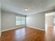 Bright bedroom with a large window and wood-look flooring, offering ample natural light at 6001 Lemon Tree Ct, Tampa, FL 33625
