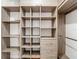 Walk-in closet featuring custom shelving and drawers for optimal organization and storage at 6001 Lemon Tree Ct, Tampa, FL 33625