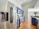Modern kitchen featuring stainless steel appliances and stylish blue cabinets with ample counter space at 6001 Lemon Tree Ct, Tampa, FL 33625