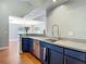 Galley kitchen featuring stainless steel appliances and stone countertops, with open access to the dining room at 6001 Lemon Tree Ct, Tampa, FL 33625