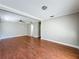 Open-concept living room with neutral walls and beautiful wood floors at 6001 Lemon Tree Ct, Tampa, FL 33625