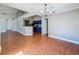 Open-concept living space with wood-look tile flooring and a view of the modern kitchen and vaulted ceilings at 6001 Lemon Tree Ct, Tampa, FL 33625