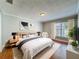 Serene main bedroom with a king-size bed, plush rug, and a large window for plenty of natural light at 6001 Lemon Tree Ct, Tampa, FL 33625