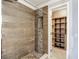 Tiled walk-in shower with built-in shelving and modern fixtures; adjacent to the primary closet at 6001 Lemon Tree Ct, Tampa, FL 33625