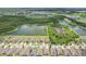 Expansive aerial view of the community showcasing numerous homes, tranquil lakes, and lush green spaces at 636 Chatham Walk Dr, Ruskin, FL 33570