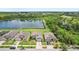Aerial view of homes with a lake backdrop and lush greenery at 636 Chatham Walk Dr, Ruskin, FL 33570