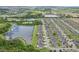 Wide aerial view of a neighborhood and surrounding greenery with a large retention pond at 636 Chatham Walk Dr, Ruskin, FL 33570
