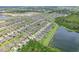 Wide aerial view showcasing an expansive suburban neighborhood with community lakes and green spaces at 636 Chatham Walk Dr, Ruskin, FL 33570