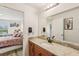Bathroom view showcasing granite vanity, mirror, and adjacent bedroom at 636 Chatham Walk Dr, Ruskin, FL 33570