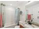 Updated bathroom with granite countertops, decorative clock, and tiled shower/bath at 636 Chatham Walk Dr, Ruskin, FL 33570