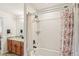 Clean bathroom featuring a shower-tub combination with a curtain, vanity, and hardwood floors at 636 Chatham Walk Dr, Ruskin, FL 33570