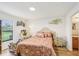 Comfortable bedroom with hardwood floors, natural light, and decorative floral accents at 636 Chatham Walk Dr, Ruskin, FL 33570