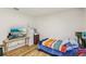 Cozy bedroom with hardwood floors, a TV, and an abundance of natural light at 636 Chatham Walk Dr, Ruskin, FL 33570