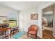 Bright dressing room featuring wood floors, natural light and a fun accent chair with a red and gold pattern at 636 Chatham Walk Dr, Ruskin, FL 33570