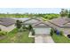 Charming single-story home featuring a well-manicured lawn and an attached two-car garage with lake view at 636 Chatham Walk Dr, Ruskin, FL 33570