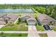 Charming single-story home with a well-maintained lawn and beautiful landscaping near a serene lake at 636 Chatham Walk Dr, Ruskin, FL 33570