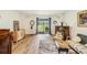 Bright living area with wood floors, neutral walls, sliding door with lake view, and vintage furniture at 636 Chatham Walk Dr, Ruskin, FL 33570