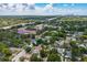Aerial view highlighting the home's location, nestled among mature trees, with city views in the distance at 6408 N Central Ave, Tampa, FL 33604