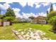 Large backyard with a storage shed and brick accents, offering ample space for recreation at 6408 N Central Ave, Tampa, FL 33604