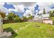 Spacious backyard with lush green grass, a storage shed, and stepping stones at 6408 N Central Ave, Tampa, FL 33604