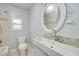 Bathroom features a tiled shower, tile accents, and a new white vanity at 6408 N Central Ave, Tampa, FL 33604