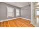 Bedroom with gray walls, refinished hardwood floors, updated windows and trim at 6408 N Central Ave, Tampa, FL 33604