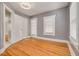 Bedroom features refinished hardwood floors, gray walls, updated windows and trim at 6408 N Central Ave, Tampa, FL 33604