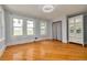 Light and airy bedroom with refinished hardwood floors, updated windows and trim, and a closet at 6408 N Central Ave, Tampa, FL 33604