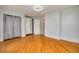 Bright bedroom features refinished hardwood floors, updated windows and trim, and a closet at 6408 N Central Ave, Tampa, FL 33604
