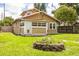 Charming home with a well-maintained yard and a brick fire pit, perfect for outdoor gatherings at 6408 N Central Ave, Tampa, FL 33604