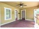 Inviting covered front porch with ceiling fan and wood flooring, a perfect place to relax and enjoy the outdoors at 6408 N Central Ave, Tampa, FL 33604