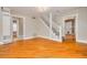 Inviting living area featuring hardwood floors, neutral walls, staircase, and multiple doorways to adjoining rooms at 6408 N Central Ave, Tampa, FL 33604