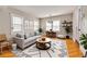 Bright living room with modern decor, wooden floors, and ample seating, perfect for relaxation and entertaining at 6408 N Central Ave, Tampa, FL 33604