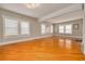 Spacious living room with hardwood floors, large windows providing plenty of natural light, and neutral wall colors at 6408 N Central Ave, Tampa, FL 33604