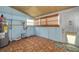 Bright utility room with a water heater, wood-look flooring, and natural light at 6408 N Central Ave, Tampa, FL 33604