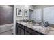 Bathroom with dual sinks and vanities featuring granite countertops at 6653 Flint Creek Dr, Land O Lakes, FL 34638