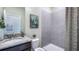 Bathroom features a shower and tub combination with gray tile and a vanity with a granite countertop at 6653 Flint Creek Dr, Land O Lakes, FL 34638