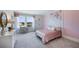 Charming bedroom featuring pink floral decor and window views at 6653 Flint Creek Dr, Land O Lakes, FL 34638