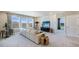 Large living room with a comfortable sofa, wall decor, and lots of natural light at 6653 Flint Creek Dr, Land O Lakes, FL 34638