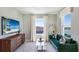 Cozy living room featuring comfortable sofa, wall decor, and natural light at 6653 Flint Creek Dr, Land O Lakes, FL 34638