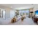 Spacious living room filled with natural light from the three large windows, and a large, comfortable sofa at 6653 Flint Creek Dr, Land O Lakes, FL 34638