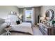 Cozy bedroom with calming decor, natural light, and a view of the lake, promoting a relaxing atmosphere at 6697 Flint Creek Dr, Land O Lakes, FL 34638