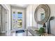 Bright entryway features tile flooring, a statement mirror, and a console table with elegant decor at 6697 Flint Creek Dr, Land O Lakes, FL 34638