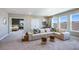 Spacious living room featuring a plush white sofa, three windows and entry to bedroom at 6697 Flint Creek Dr, Land O Lakes, FL 34638