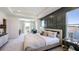 Spacious main bedroom with water view, lounge area and decorative accent wall at 6697 Flint Creek Dr, Land O Lakes, FL 34638