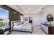 Bright main bedroom with a decorative wall, neutral color palette, and large windows offering picturesque views at 6697 Flint Creek Dr, Land O Lakes, FL 34638